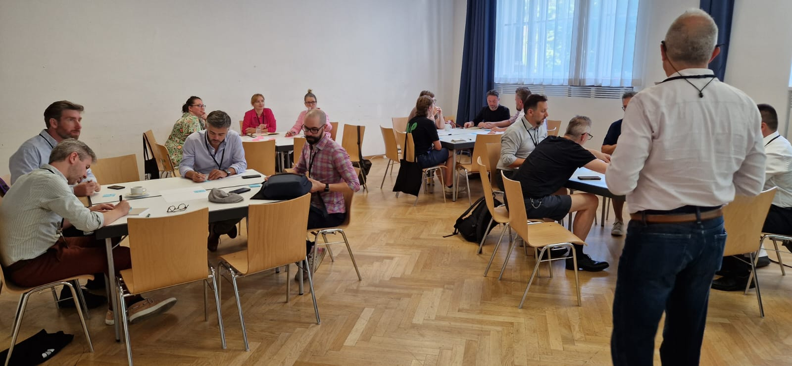 Strategic facilitation session with teams engaged in collaborative exercises